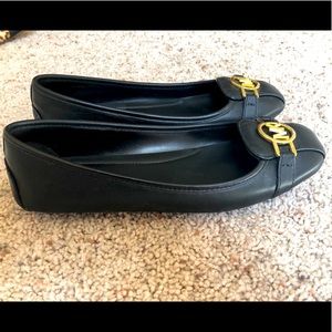 Black pair of Michael Kors flats